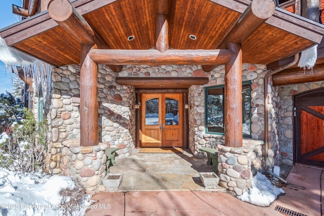 doorway to property with stone siding