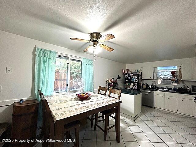 204 W 12th St, Craig, CO 81625 - dining room featuring a ceiling fan, a textured ceiling, and light tile patterned flooring