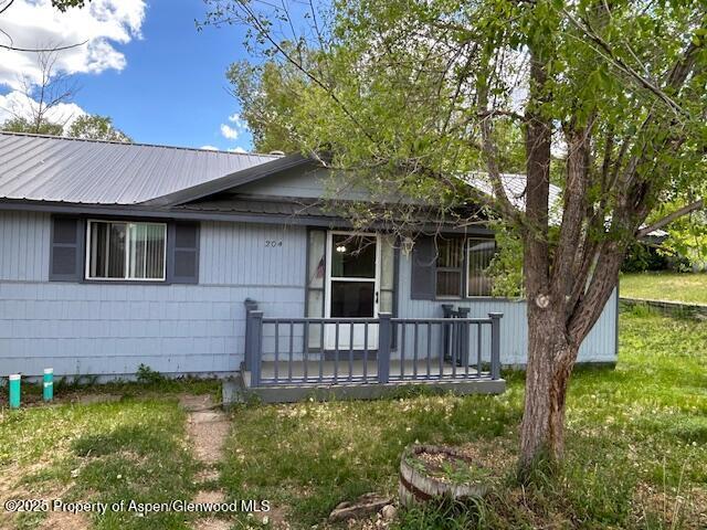 204 W 12th St, Craig, CO 81625 - view of front facade featuring a metal roof and covered porch