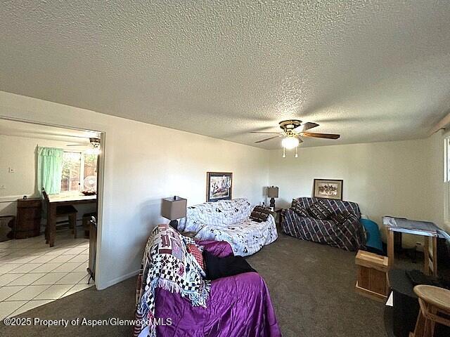 204 W 12th St, Craig, CO 81625 - bedroom featuring light colored carpet, a textured ceiling, and a ceiling fan