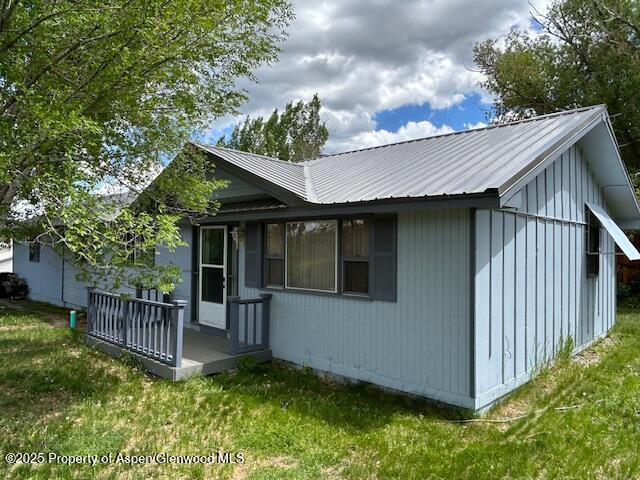 204 W 12th St, Craig, CO 81625 - view of side of property with a lawn and a metal roof