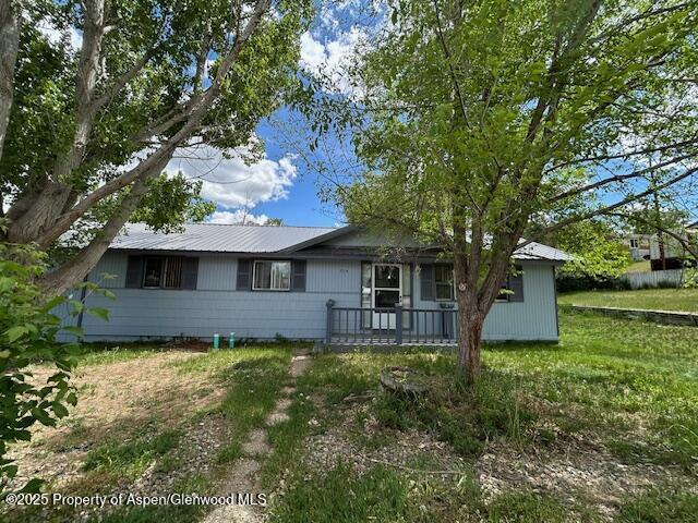 204 W 12th St, Craig, CO 81625 - ranch-style home with a metal roof