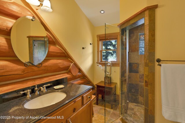1373 Mclaughlin Ln, Basalt, CO 81621 - bathroom with stone tile flooring, vanity, a tile shower, and recessed lighting