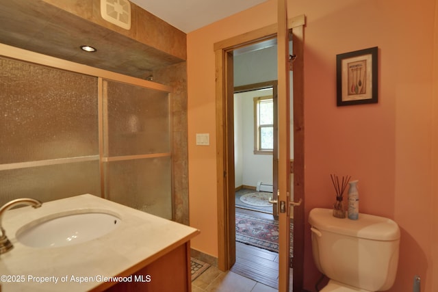 1373 Mclaughlin Ln, Basalt, CO 81621 - bathroom with baseboard heating, toilet, vanity, a stall shower, and tile patterned floors