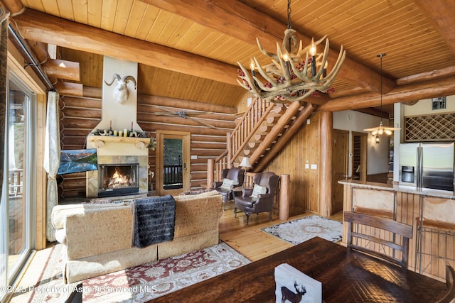 1373 Mclaughlin Ln, Basalt, CO 81621 - living room with log walls, wood ceiling with exposed beams, stairway, hardwood / wood-style floors, and ceiling fan