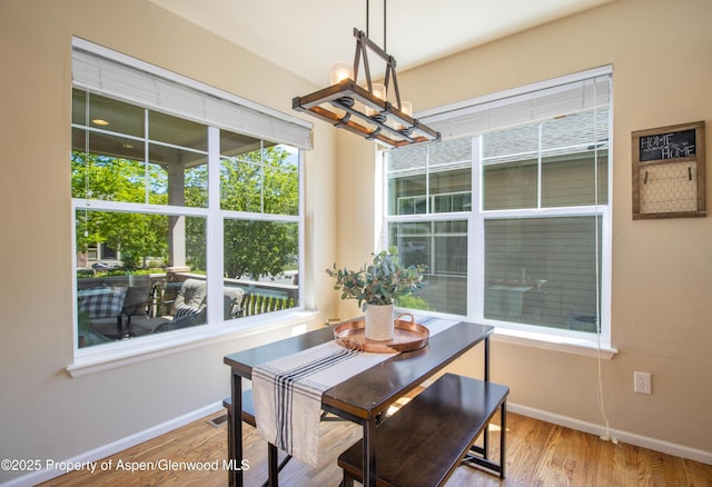 41 Red Cloud Ct, New Castle, CO 81647 - dining area with a chandelier, baseboards, and wood finished floors