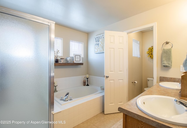 41 Red Cloud Ct, New Castle, CO 81647 - bathroom with tile patterned flooring, a garden tub, double vanity, and toilet