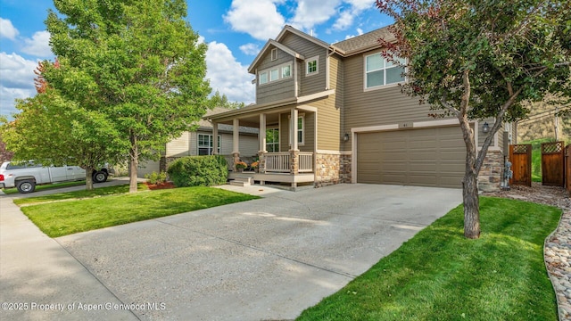 41 Red Cloud Ct, New Castle, CO 81647 - view of front of property with a garage, covered porch, driveway, and stone siding