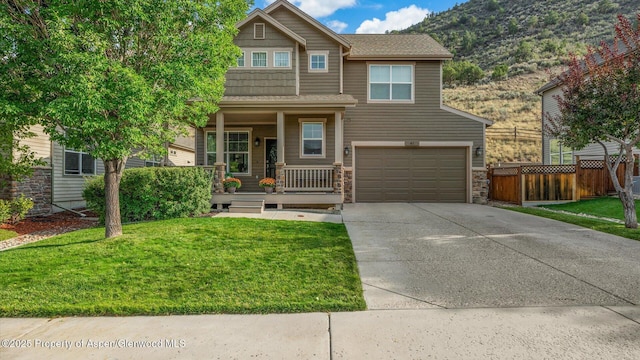 41 Red Cloud Ct, New Castle, CO 81647 - craftsman-style house featuring a porch, a garage, driveway, stone siding, and a mountain view