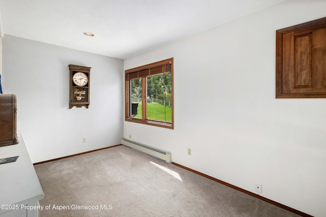 unfurnished room with a baseboard heating unit, recessed lighting, light carpet, and baseboards
