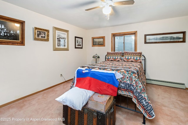 bedroom with ceiling fan, carpet flooring, a baseboard heating unit, and baseboards