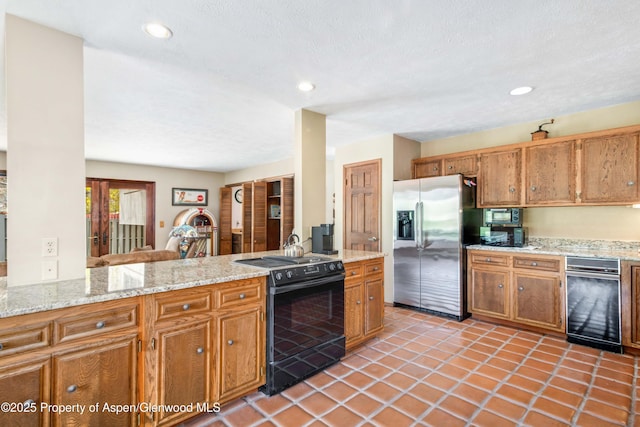 kitchen featuring black range with electric cooktop, stainless steel refrigerator with ice dispenser, and brown cabinets