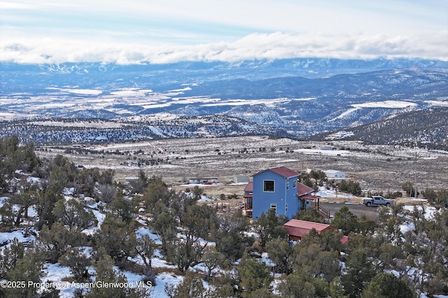 snowy aerial view with a mountain view