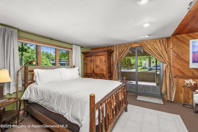 125 E Hyman Ave Unit 1A, Aspen, CO 81611 - bedroom featuring multiple windows, access to outside, carpet floors, and wood walls