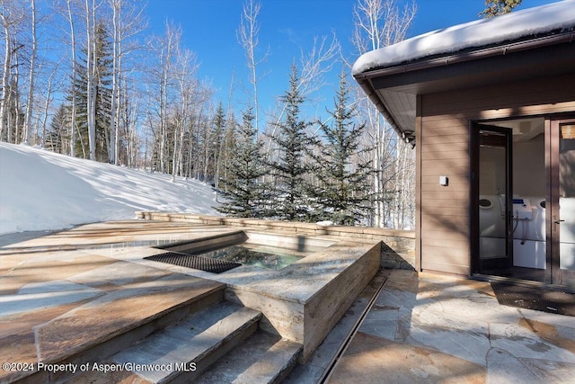 snow covered patio with a jacuzzi