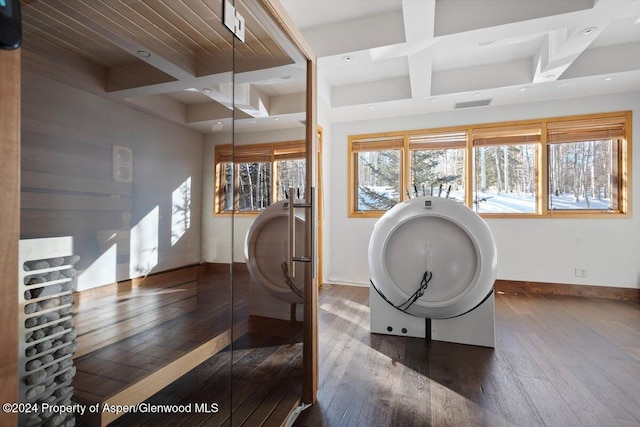 interior space featuring a wealth of natural light, dark hardwood / wood-style flooring, beamed ceiling, and coffered ceiling