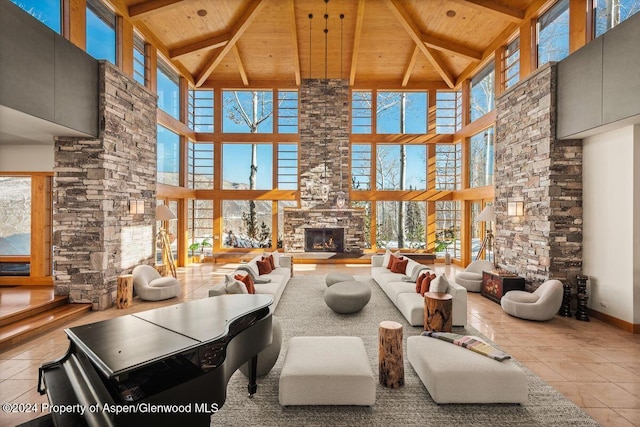 living room featuring a high ceiling, a stone fireplace, wood ceiling, and light tile patterned flooring