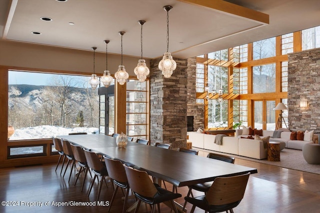 dining room featuring a mountain view and expansive windows