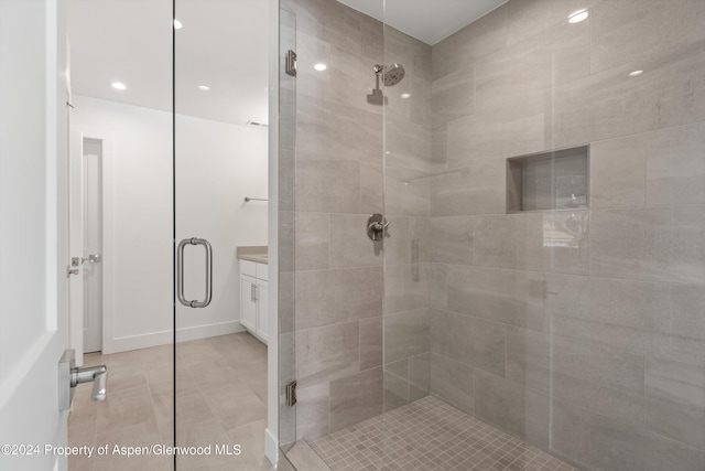 bathroom with vanity and a shower with shower door