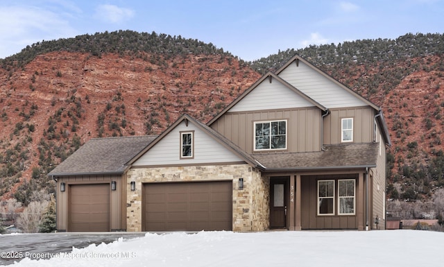 view of front of property with a mountain view and a garage