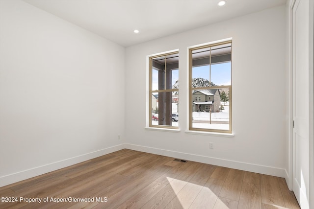 spare room featuring light hardwood / wood-style flooring