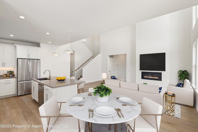 dining area featuring sink and light hardwood / wood-style flooring