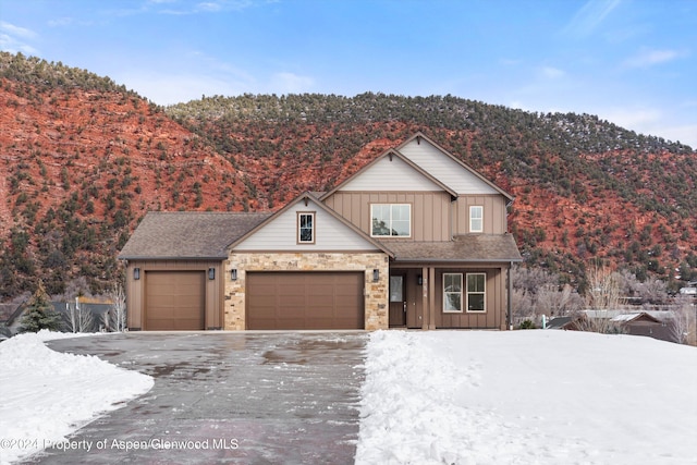 view of property featuring a mountain view and a garage