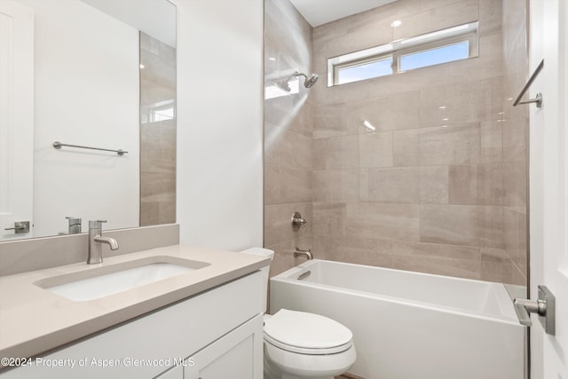 full bathroom with vanity, toilet, and tiled shower / bath