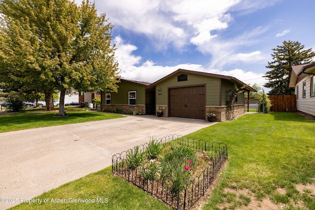 single story home featuring an attached garage, concrete driveway, and stone siding