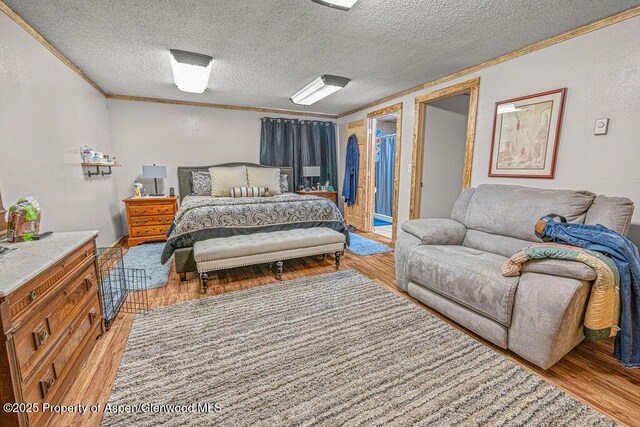 110 Western Ave, Craig, CO 81625 - bedroom featuring ornamental molding, light wood finished floors, a textured ceiling, and a textured wall