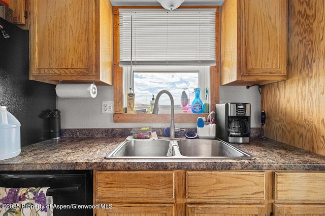 110 Western Ave, Craig, CO 81625 - kitchen featuring dark countertops, black dishwasher, and brown cabinetry