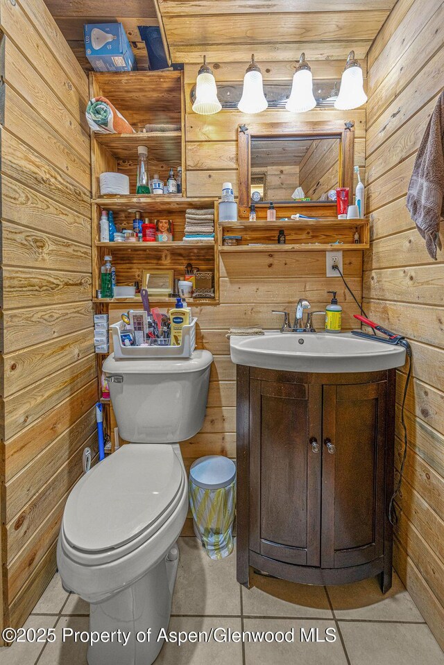 110 Western Ave, Craig, CO 81625 - half bath with wooden walls, vanity, and tile patterned floors