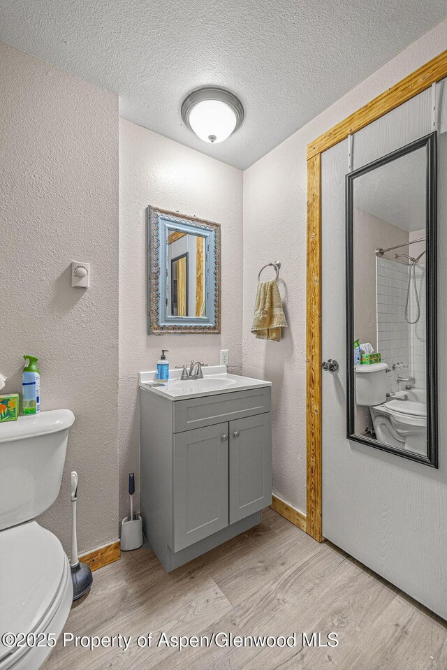 110 Western Ave, Craig, CO 81625 - bathroom with wood finished floors, vanity, a textured wall, a textured ceiling, and a shower