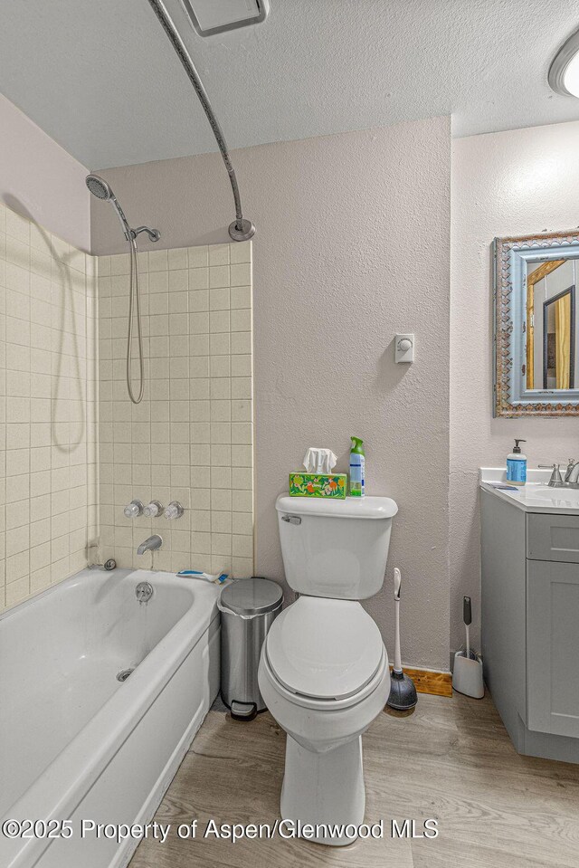110 Western Ave, Craig, CO 81625 - full bathroom with wood finished floors, shower / tub combination, vanity, a textured wall, and a textured ceiling