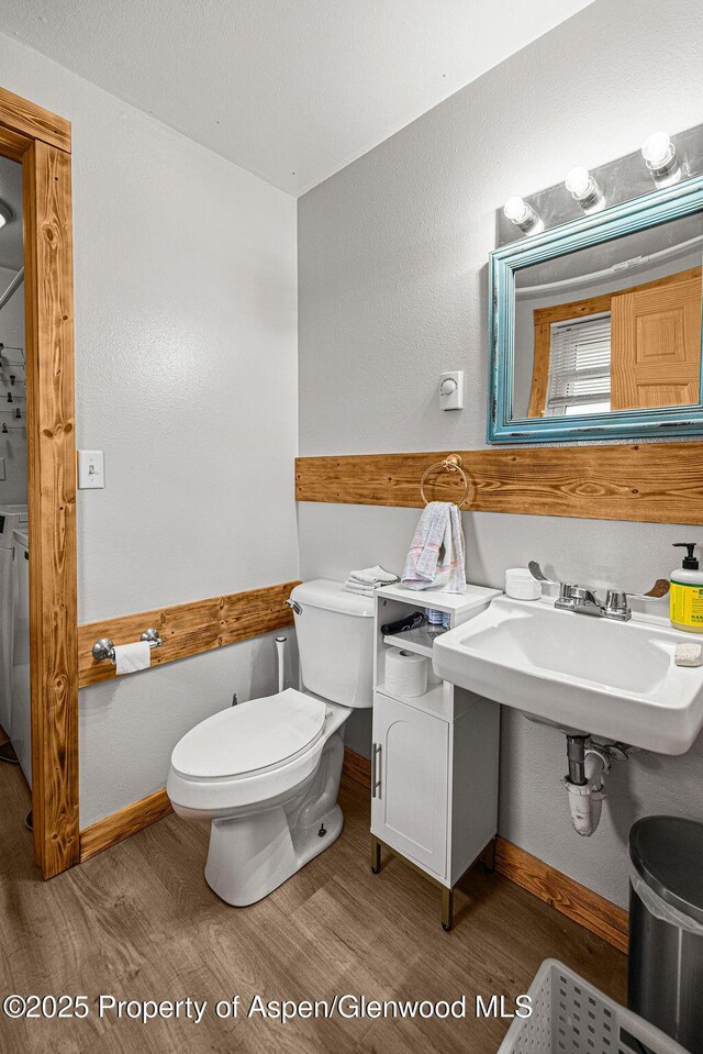 110 Western Ave, Craig, CO 81625 - bathroom featuring wood finished floors and washer / clothes dryer