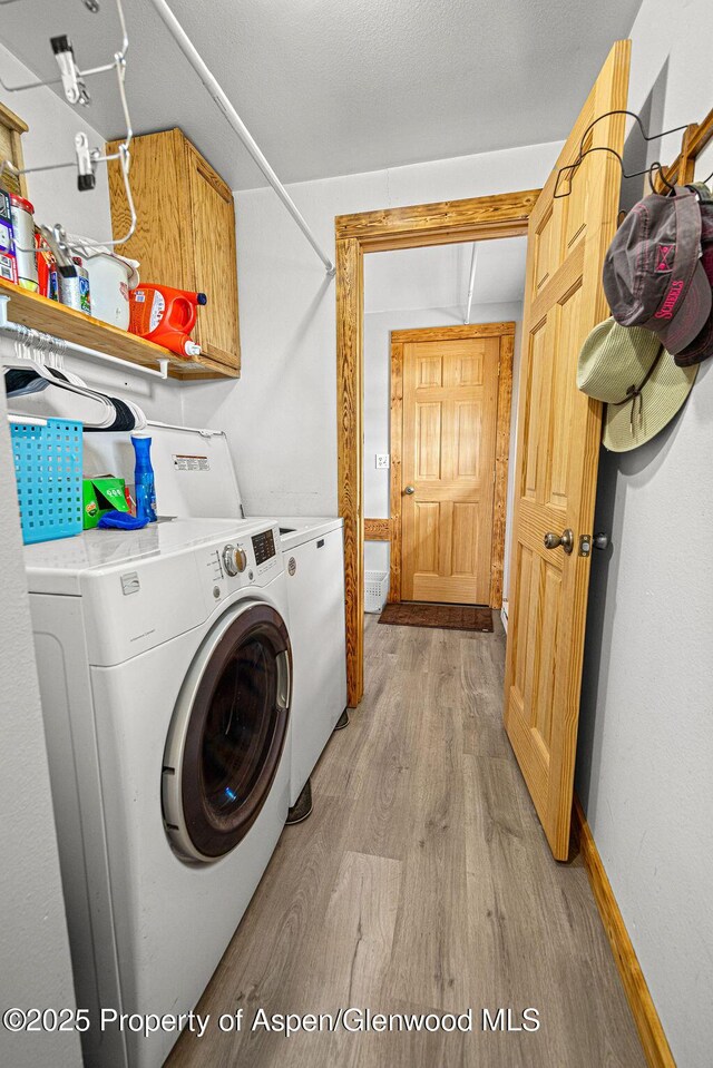 110 Western Ave, Craig, CO 81625 - laundry room featuring cabinet space, light wood finished floors, and washer and dryer
