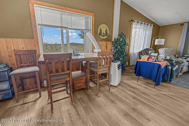 110 Western Ave, Craig, CO 81625 - dining area featuring lofted ceiling, plenty of natural light, wood finished floors, and a textured ceiling