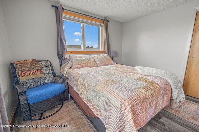 110 Western Ave, Craig, CO 81625 - bedroom with wood finished floors and a textured ceiling