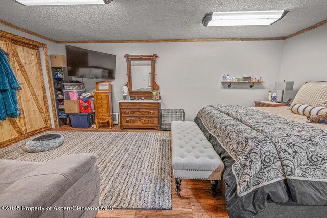 110 Western Ave, Craig, CO 81625 - bedroom featuring ornamental molding, wood finished floors, and a textured ceiling