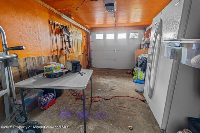 110 Western Ave, Craig, CO 81625 - garage featuring white refrigerator with ice dispenser and a garage door opener