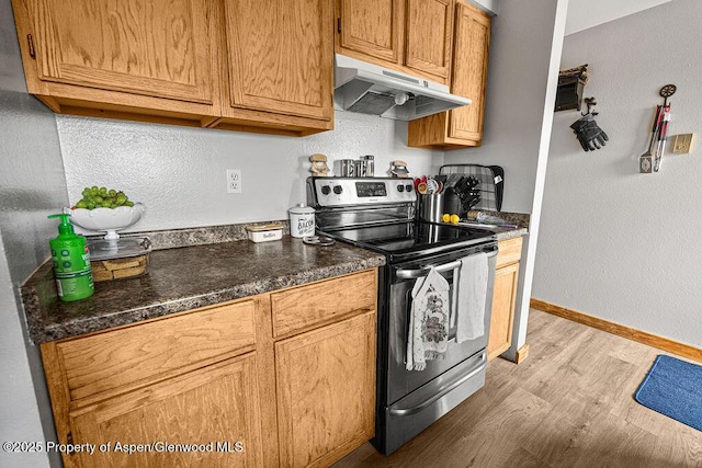 110 Western Ave, Craig, CO 81625 - kitchen with electric range, under cabinet range hood, light wood finished floors, and dark countertops