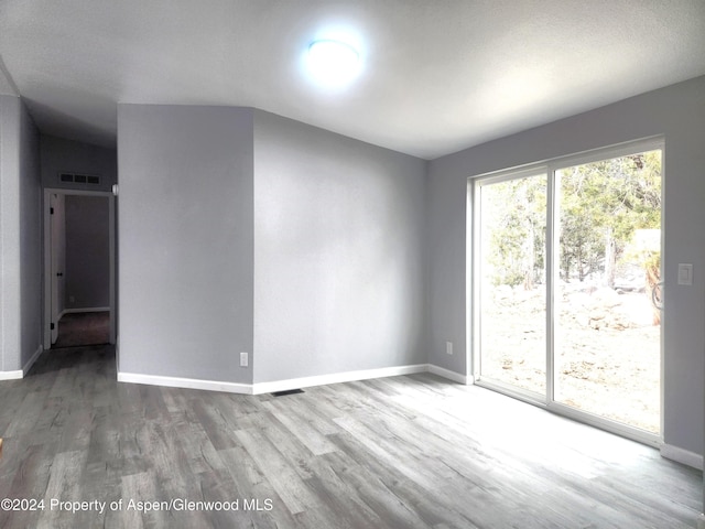 unfurnished room featuring hardwood / wood-style floors