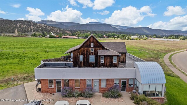 1000 Dolores Way Unit C, Carbondale, CO 81623 - back of property featuring a mountain view, brick siding, a yard, and a rural view