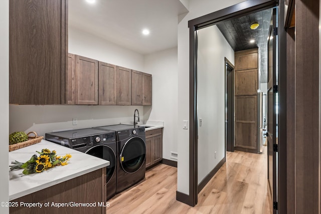 129 Sage Meadow Rd, Glenwood Springs, CO 81601 - washroom with baseboards, light wood-type flooring, a sink, cabinet space, and independent washer and dryer