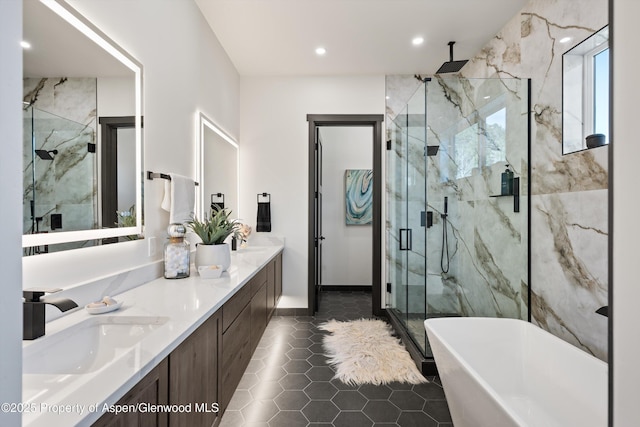 129 Sage Meadow Rd, Glenwood Springs, CO 81601 - full bath featuring double vanity, tile patterned floors, a soaking tub, a sink, and a marble finish shower
