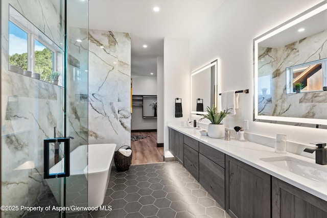 129 Sage Meadow Rd, Glenwood Springs, CO 81601 - bathroom with a sink, double vanity, recessed lighting, tile walls, and a soaking tub