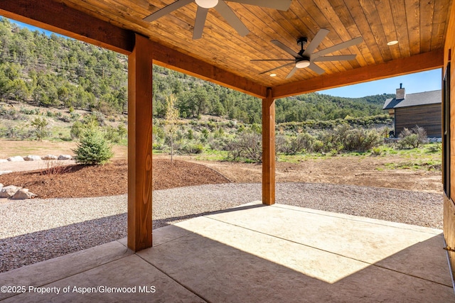 129 Sage Meadow Rd, Glenwood Springs, CO 81601 - view of patio / terrace with a ceiling fan, a mountain view, and a wooded view