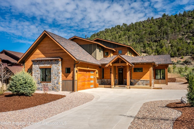 129 Sage Meadow Rd, Glenwood Springs, CO 81601 - view of front facade featuring an attached garage, driveway, and stone siding