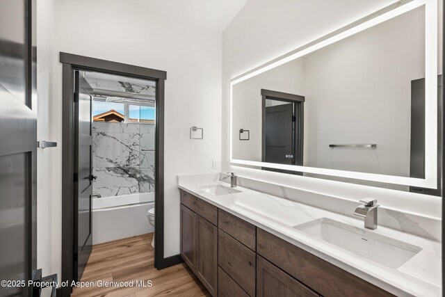 129 Sage Meadow Rd, Glenwood Springs, CO 81601 - bathroom featuring double vanity, a sink, wood finished floors, and toilet