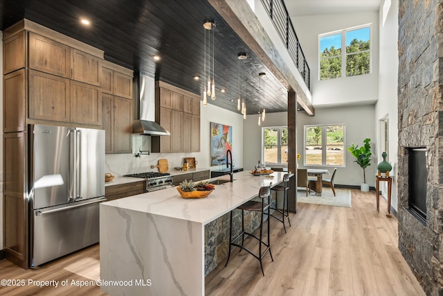 129 Sage Meadow Rd, Glenwood Springs, CO 81601 - kitchen featuring premium appliances, a healthy amount of sunlight, a sink, and wall chimney exhaust hood